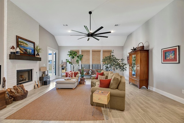 living room with ceiling fan and a brick fireplace