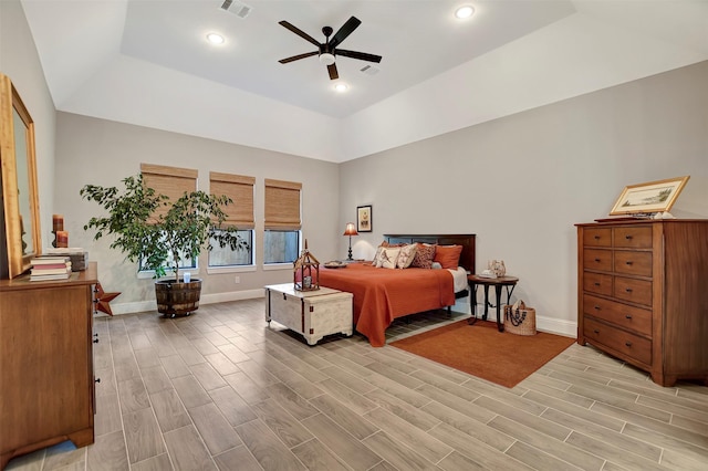 bedroom with ceiling fan and a tray ceiling