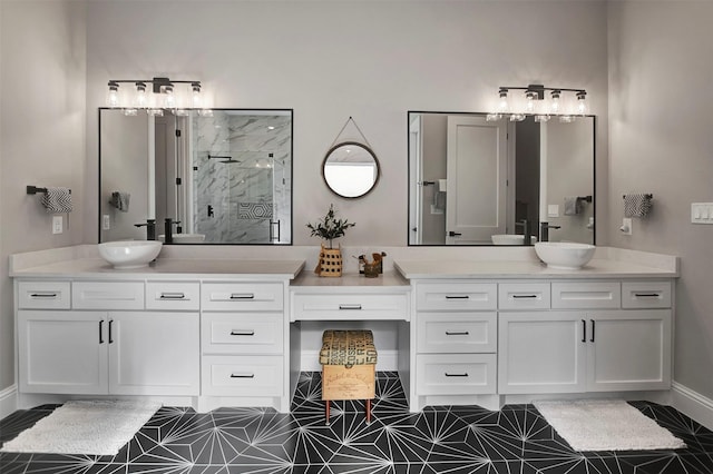 bathroom featuring a shower with shower door and vanity