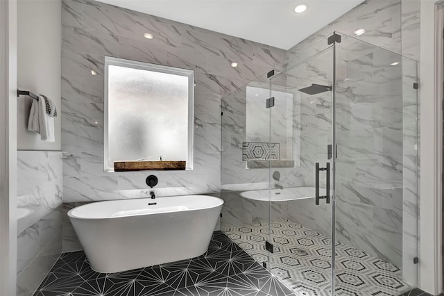 bathroom featuring tile walls and separate shower and tub