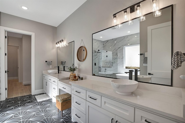 bathroom featuring a shower with shower door and vanity