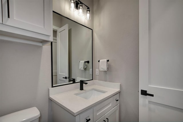 bathroom featuring toilet and vanity