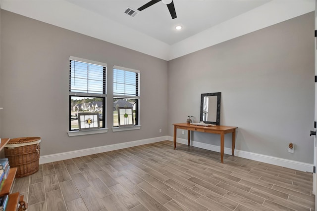 interior space featuring light hardwood / wood-style floors, ceiling fan, and vaulted ceiling