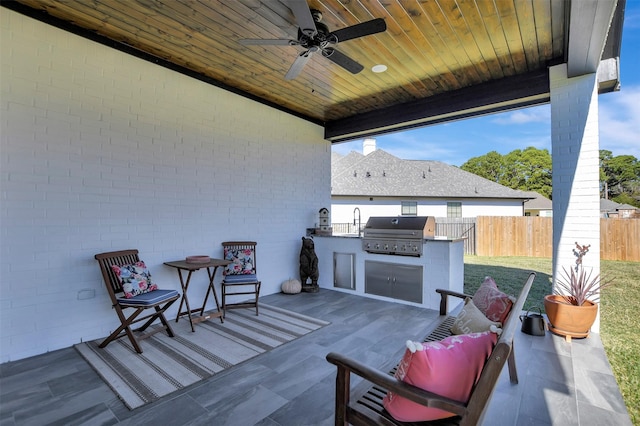 view of patio with ceiling fan, an outdoor kitchen, and grilling area