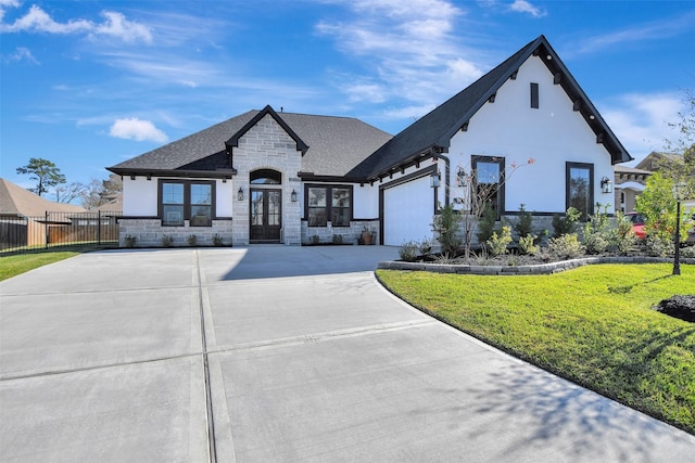 view of front of house with a front yard and a garage