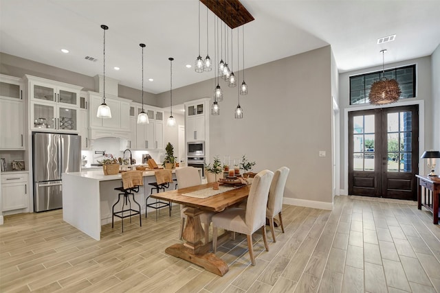 dining space with french doors and sink