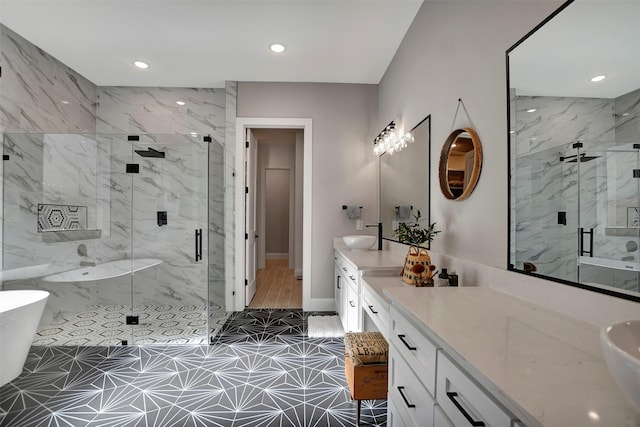 bathroom with vanity and shower with separate bathtub