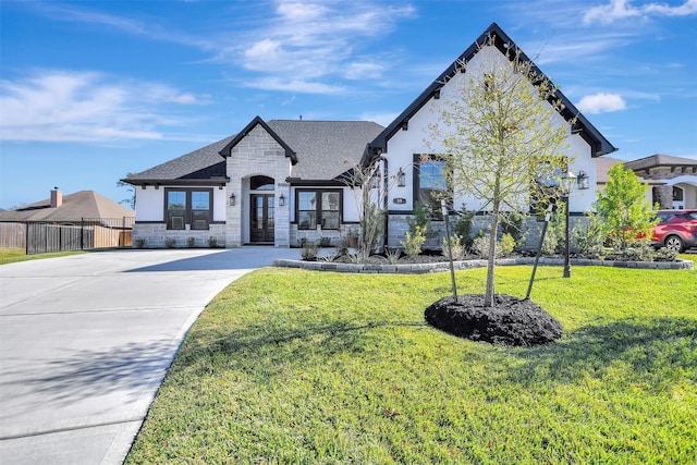 french country inspired facade with a front yard