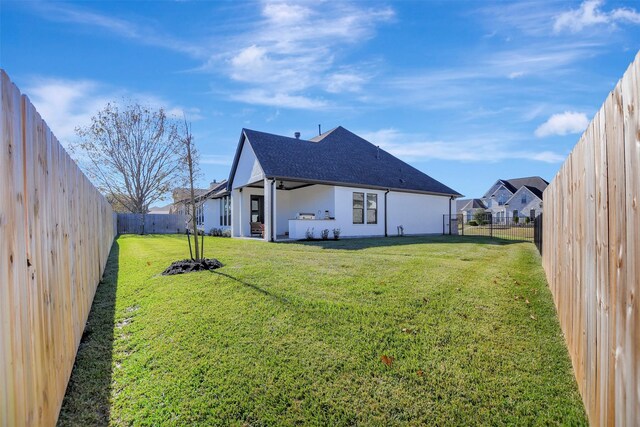 rear view of house featuring a yard