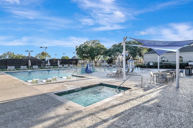 view of pool featuring a patio and a community hot tub