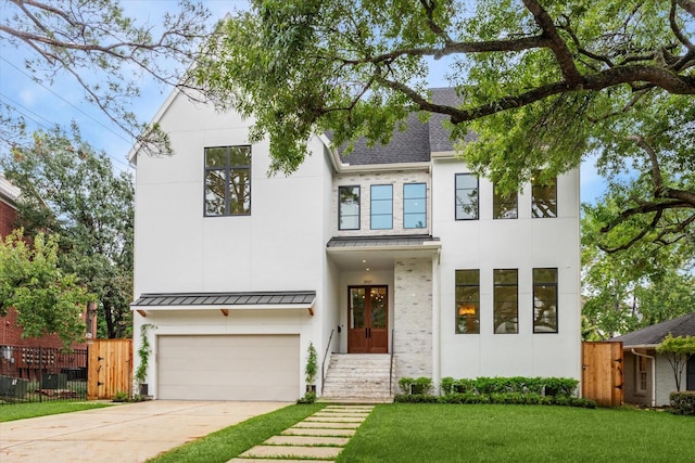 view of front of property with a front lawn and a garage