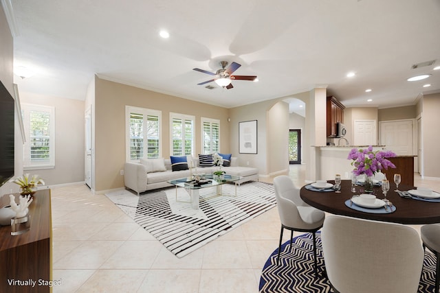 living room with ceiling fan, light tile patterned floors, and crown molding