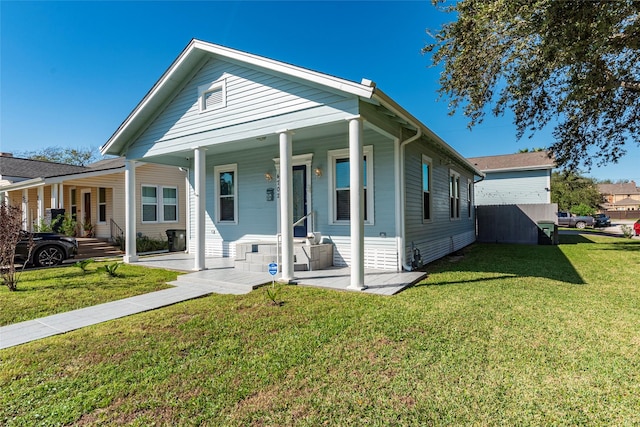 view of front of home featuring covered porch and a front lawn