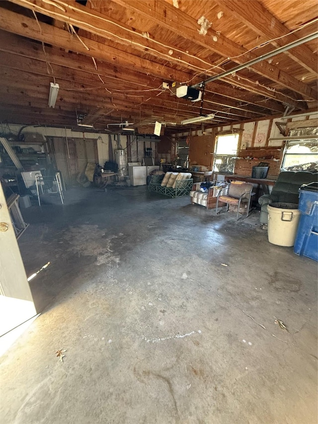 garage with a garage door opener, washer / dryer, and gas water heater