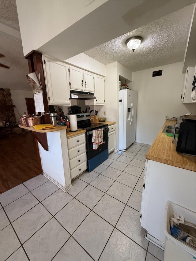 kitchen featuring electric stove, white cabinetry, white refrigerator with ice dispenser, a textured ceiling, and light tile patterned floors