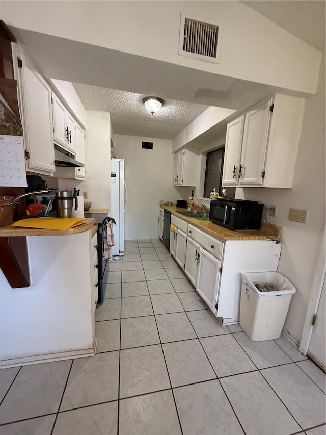 kitchen with black appliances, sink, white cabinetry, a textured ceiling, and light tile patterned floors