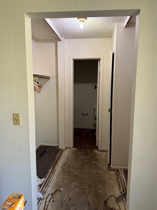 corridor with a textured ceiling