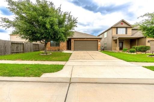 view of front of property with a garage and a front lawn