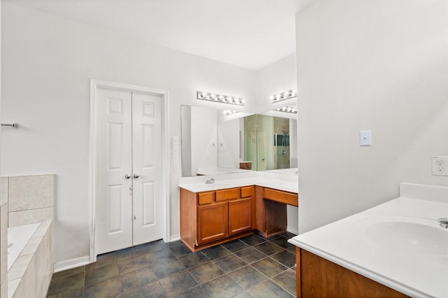 bathroom with tiled bath and vanity