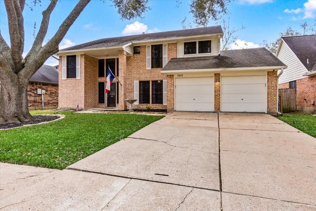 view of front facade with a front lawn and a garage