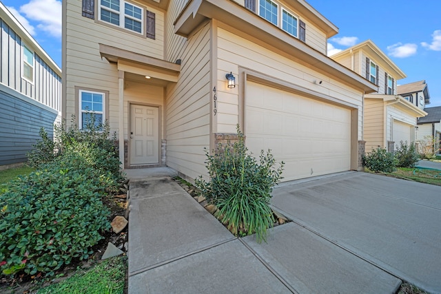 doorway to property with a garage