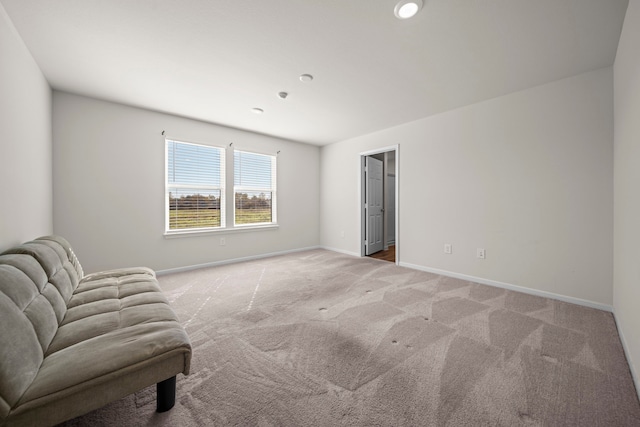 unfurnished room featuring light carpet