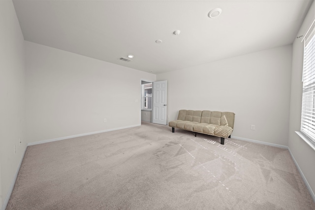 unfurnished room featuring light colored carpet