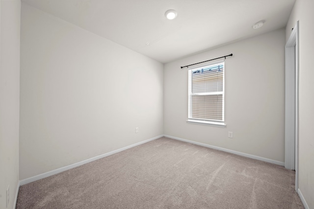 unfurnished room with light carpet