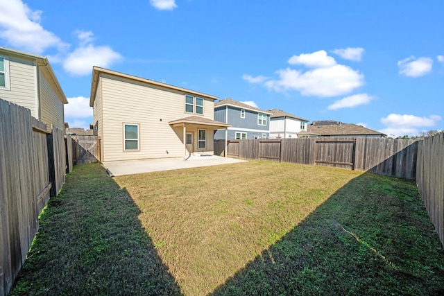 rear view of property featuring a patio area and a lawn