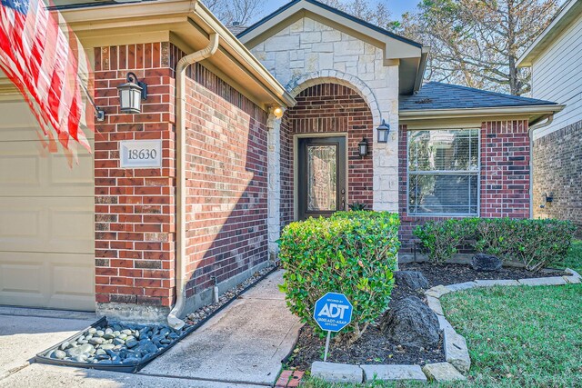 view of exterior entry with a garage