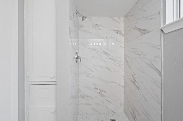 interior details with a tile shower