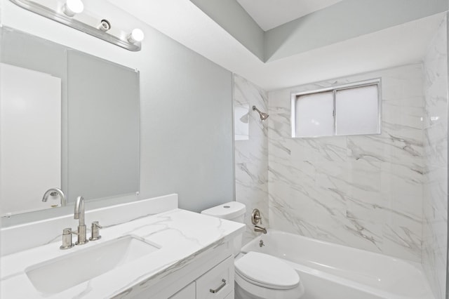 full bathroom featuring toilet, vanity, and tiled shower / bath