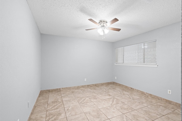 tiled empty room with a textured ceiling and ceiling fan