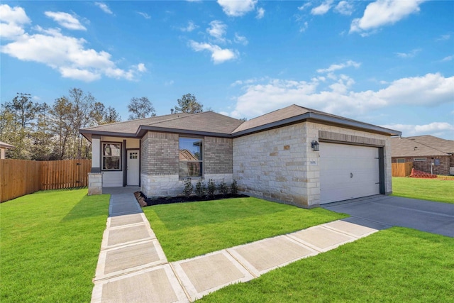 view of front of property featuring a garage and a front lawn