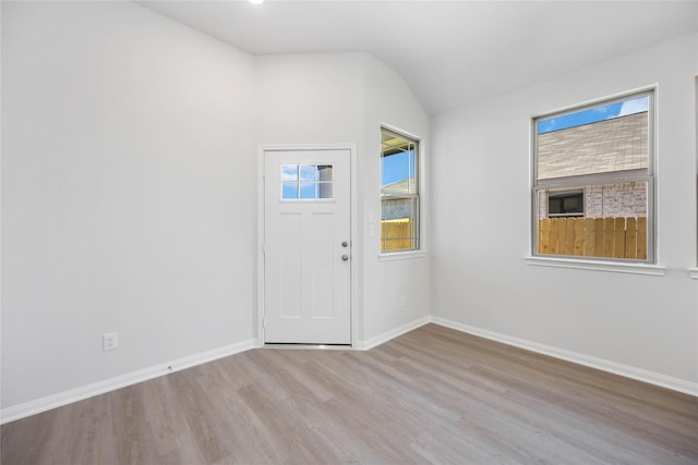 foyer featuring light hardwood / wood-style flooring and lofted ceiling