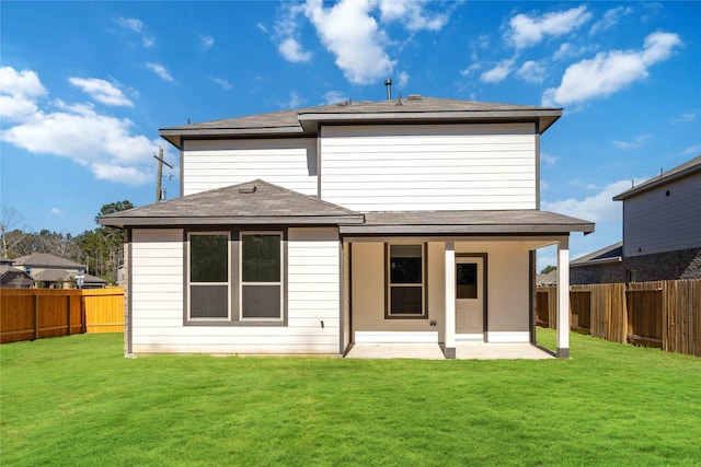 back of house with a lawn and a patio area