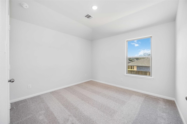 empty room with carpet floors and vaulted ceiling