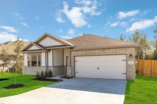 view of front of house featuring a garage and a front yard