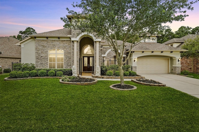 view of front of home featuring a lawn and a garage