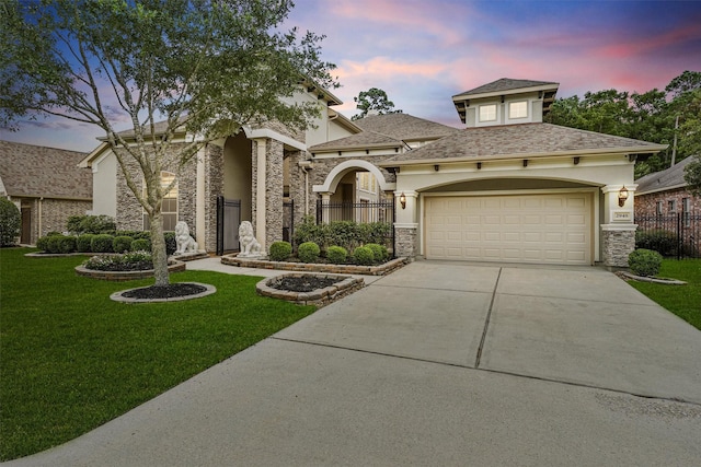 view of front of property with a garage and a lawn