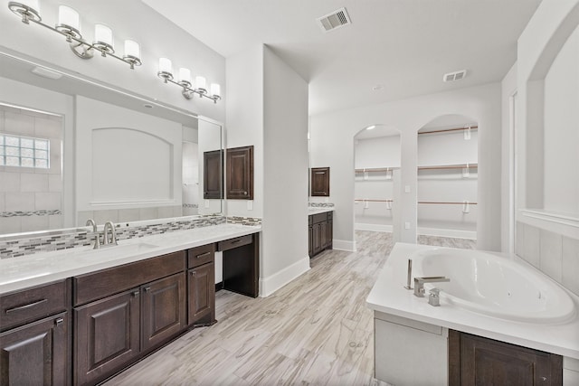 bathroom featuring vanity, a bathtub, and hardwood / wood-style flooring