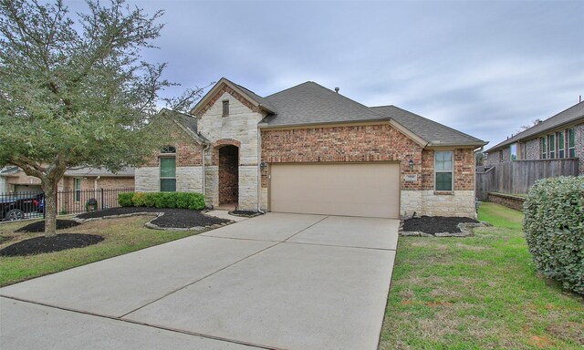 view of front of house featuring a front yard and a garage