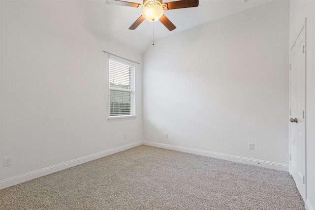 empty room with carpet floors, vaulted ceiling, baseboards, and ceiling fan