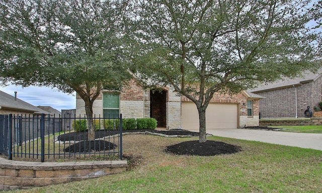 view of front of property with an attached garage, brick siding, fence, driveway, and a front lawn