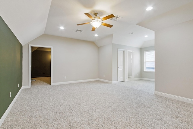 unfurnished room featuring lofted ceiling, visible vents, and light carpet