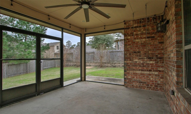 unfurnished sunroom featuring a ceiling fan