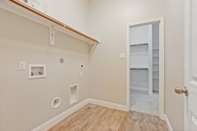 laundry area with laundry area, gas dryer hookup, hookup for a washing machine, hookup for an electric dryer, and light wood-style floors