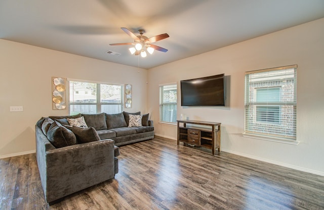 living room with ceiling fan and dark wood-type flooring