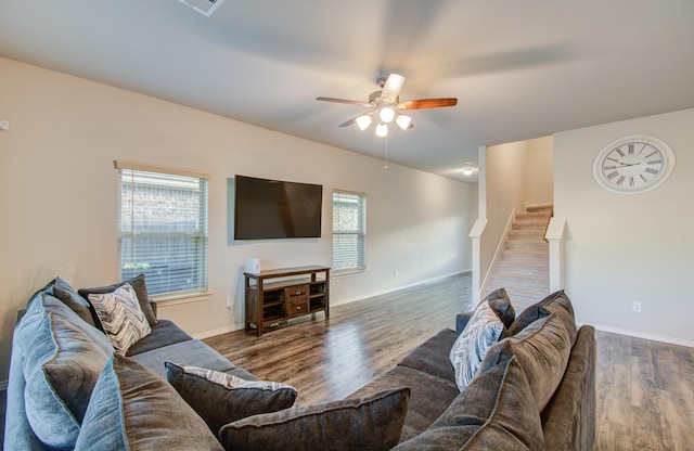 living room with ceiling fan and dark wood-type flooring