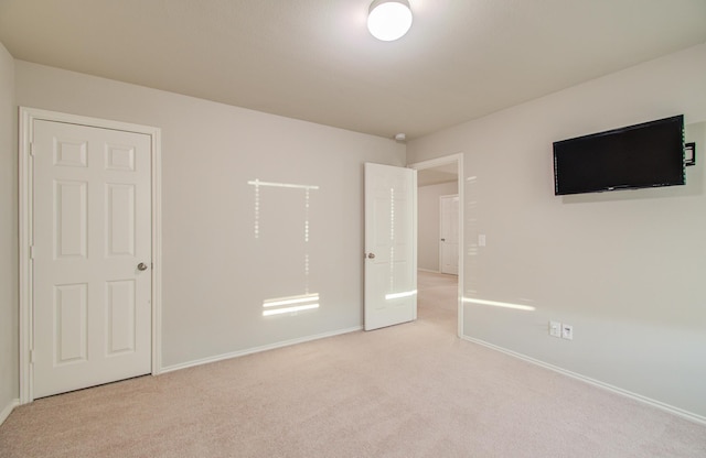 unfurnished bedroom featuring light colored carpet